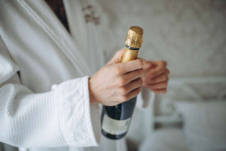 man open champagne bottle on white backgroundの写真素材