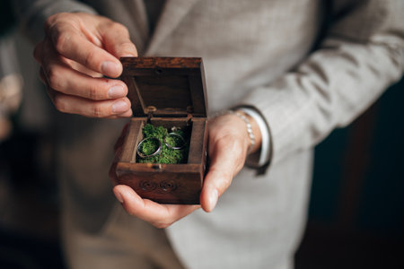 gold wedding rings in the hands of groomの写真素材