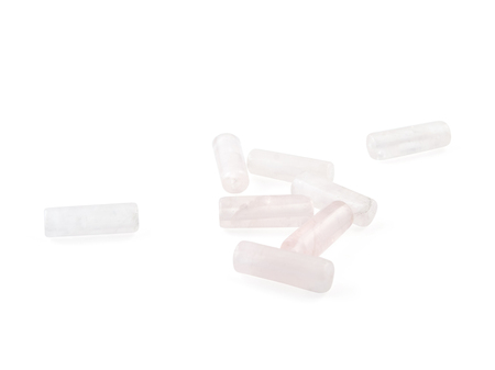 Rose quartz, beads pink stone in front of white background.
