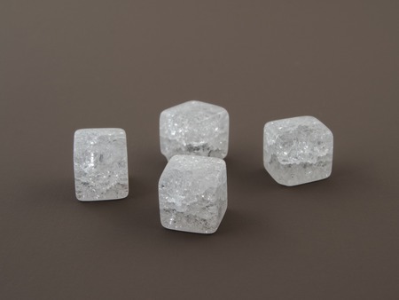 Crackle glass or Sugar quartz beads on a beautiful brown backgroundの写真素材