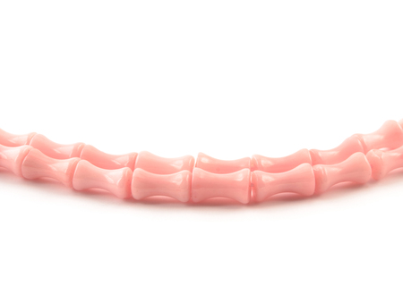 Natural gemstone pink coral beads on a white background.の写真素材