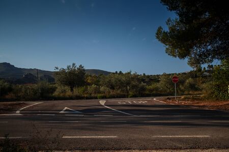 Road junction with stop sign in a rural roadの写真素材