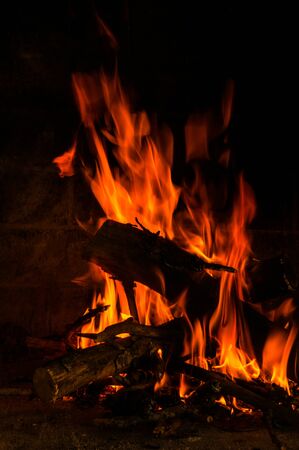 burning woods with flames in the fireplaceの写真素材