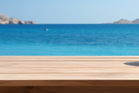 Wooden table on the backdrop of a blue sea, white sand beach, clear blue sky. Space for product or object presentation.の素材