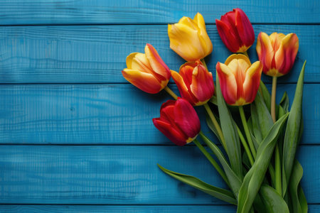 Bouquet of colorful tulips on a blue wooden background.の素材