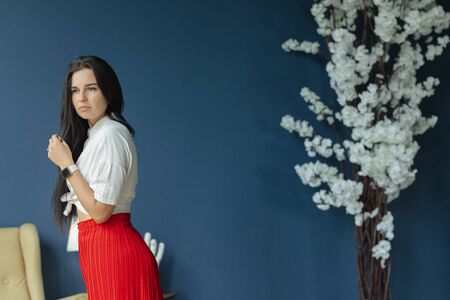 portrait of gorgeous brunette in white shirt and wide legs pans with perfect skin. fashion young...