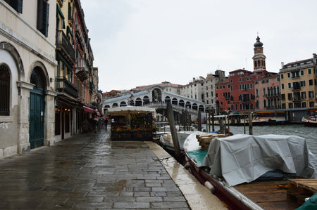 Venice, Famous Rialto Bridge with typical venetian restaurant and Canal Grande on the right, raining and cloudy day, Venice, Italy summer 2016のeditorial素材