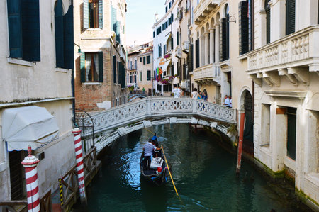 Typical Venice canal with boats and bridge in the bottom, Italy summer 2016のeditorial素材
