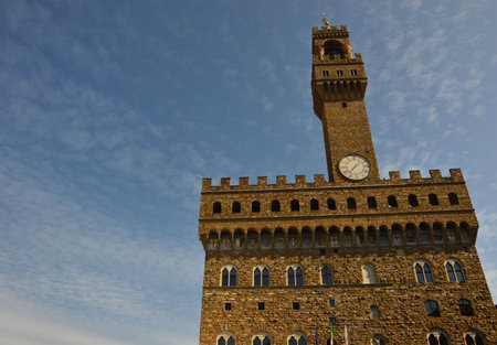 Old Palace called Palazzo Vecchio and clock tower with blue sky with clouds in Signoria square in Florence, Italyのeditorial素材