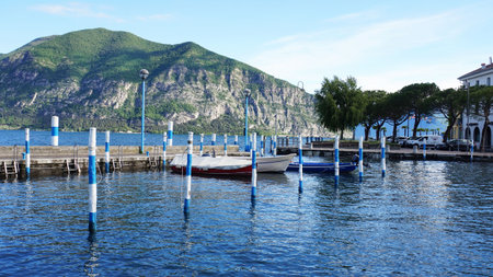 ISEO, ITALY - MAY 13, 2017: View of the pier of Iseo Lake with boats, Iseo, Italyのeditorial素材