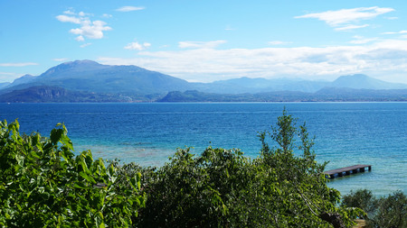 Amazing view of Lake Garda from the park Parco Pubblico Tomelleri in Sirmione town, Italyの写真素材