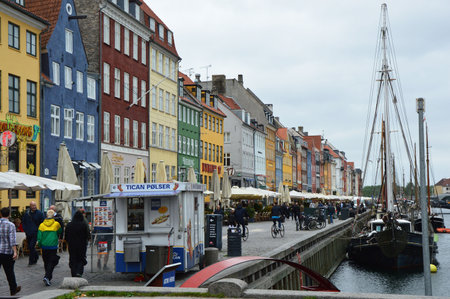 COPENHAGEN, DENMARK - MAY 31, 2017: tourists in open cafes of famous Nyhavn promenade. Nyhavn a 17th century harbor in Copenhagen with typical colorful houses and water canals, Copenhagen, Denmarkのeditorial素材