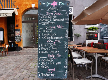 COPENHAGEN, DENMARK - MAY 31, 2017: Blackboard restaurant menu on the Nyhavn canal. Nyhavn is...