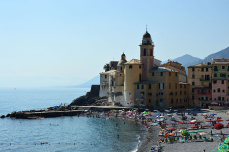 CAMOGLI, ITALY - JUNE 13, 2017: tourists on the beach with Basilica of Santa Maria Assunta on the background, Camogli, Liguria, Italyのeditorial素材