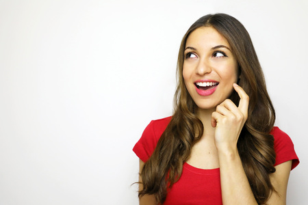 Smiling young woman with red t-shirt looking at the side. Copy space.の写真素材