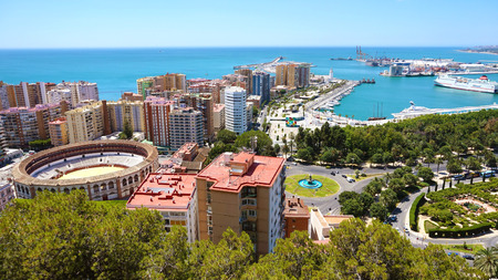 Panoramic banner view of Malaga City. Cityscape of Malaga with down town center with Mediterranean Sea port harbor and bullring from Gibralfaro viewpoint, Malaga, Andalusia, Spain.の写真素材
