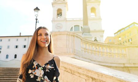 Portrait of fashion beautiful young woman goes down the Spanish Steps famous landmark of Rome. Summer holidays in Italy. Copy space area.の写真素材
