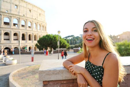 Roman Holiday. Smiling beautiful tourist girl in Rome, Italy. Attractive fashion woman with Colosseum on the background.の写真素材