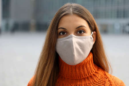 Close up of girl wearing face mask posing in the street looking at camera
