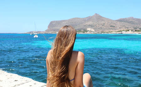 Holidays in Sicily. Back view of bikini girl in Favignana, Aegadian Islands.の写真素材
