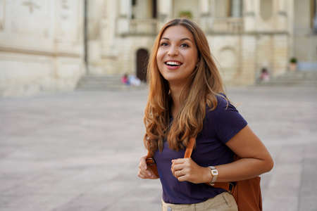 Brazilian female tourist laughing outdoors. Beautiful traveler girl joyful on her jouney in Europe.の写真素材