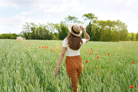 Back view of a young woman who regenerates herself walking in the natureの写真素材
