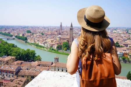 Traveler girl in Verona, Italy. Backpacker enjoying visiting Europe. Young tourist people traveling alone.の写真素材