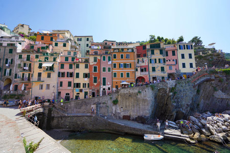 RIOMAGGIORE, ITALY - JULY 20, 2021: colorful houses overhanging cliffs in the National Park of Cinque Terre, Liguria, Italyのeditorial素材
