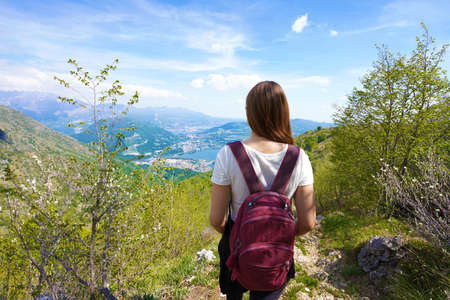 Female hiker trekking on mountains enjoying view from belvedere