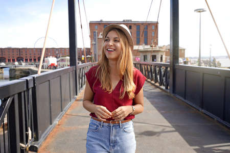 Attractive fashion girl walking on Swing Bridge in Royal Albert Dock, Liverpool, UKの写真素材