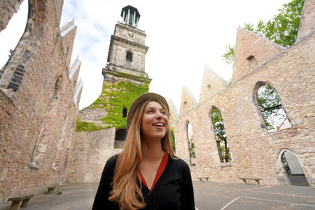Young woman visiting the ruins of the church of Aegidienkirche in Hanover, Germanyの写真素材