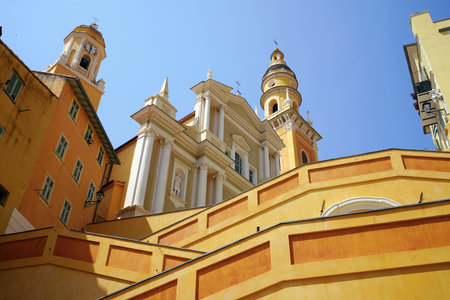 Glimpse of Menton Basilica of St. Michael the Archangel, Menton, French Riviera, Europeの写真素材