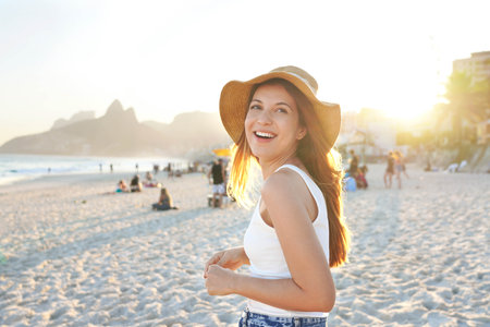 Healthy beautiful young woman smiling on Ipanema beach. Delightful laughing  girl enjoying sunset in Rio de Janeiro, Brazil.の写真素材