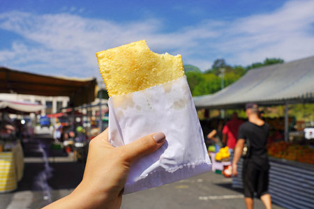 Pastel de Feira. Brazilian stuffed fried pastry against market fair in Sao Paulo, Brazil.の写真素材