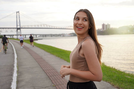 Portrait of pretty young woman relaxing at crepuscle on promenade Beira-mar Norte in Florianopolis, Santa Catarina, Brazilの写真素材