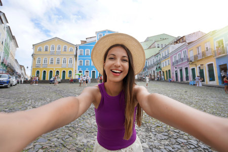 Tourism in Salvador de Bahia. Selfie photo of beautiful smiling girl visiting the famous historic center of Salvador de Bahia, Brazil.の写真素材