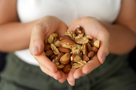 Woman hands showing a variety of nuts mix of dried fruits.の写真素材