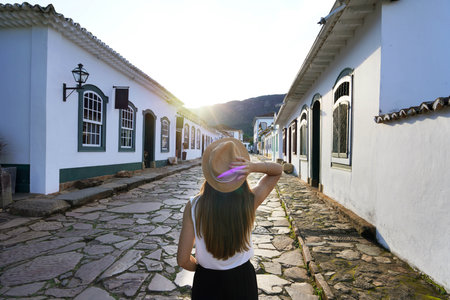 Tourist woman in the historic colonial village of Tiradentes at sunset in Brazilの写真素材
