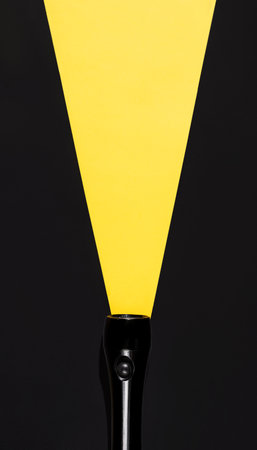 Flashlight with luminous beam made of paper, top view. Search concept, copy space. Creative vertical photo, place for your ad.の写真素材