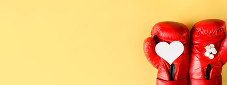 Heart and pills on boxing gloves, top view. Banner, copy space. Injury sport concept. Anesthetic for the athleteの写真素材