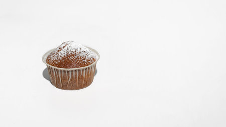 Muffin on a white table. Banner, free space for text on the right. minimalism food photoの写真素材