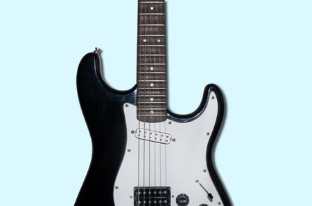 Electric guitar isolated on a light blue background, crop. Guitar body close up.の写真素材