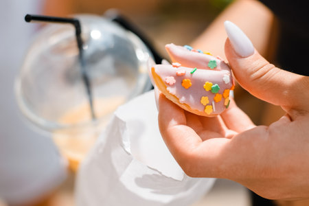 Female hands holding cookies outdoors close-up.の写真素材