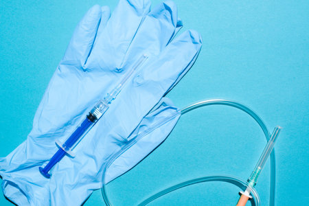 Medical equipment, close-up. Syringe, gloves, dropper on a blue background, flat lay.の写真素材