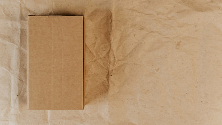 Brown cardboard box and wrapping paper. top view mockup. Place for logo, announcement, text. Gift,...
