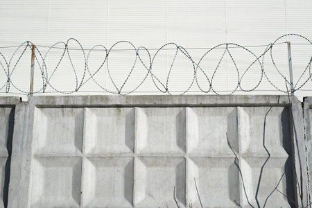Concrete fence with barbed wire. Prison, security zone conceptの写真素材
