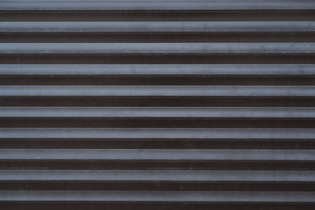 Iron automatic blinds, roller shutters close-up, outside. textured back