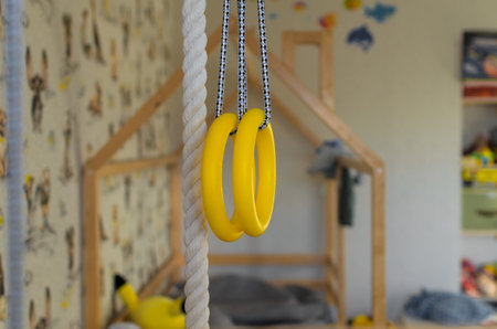Children's wall bars, rope and athletic rings in the room, selective focus.の写真素材