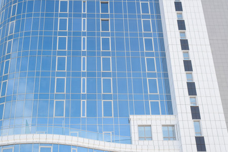 skyscraper close-up. Building made of glass and tiles on a clear day outsideの写真素材