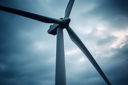 Alternative eco energy. Close-up of a wind farm generator on a cloudy day against the sky.の素材
